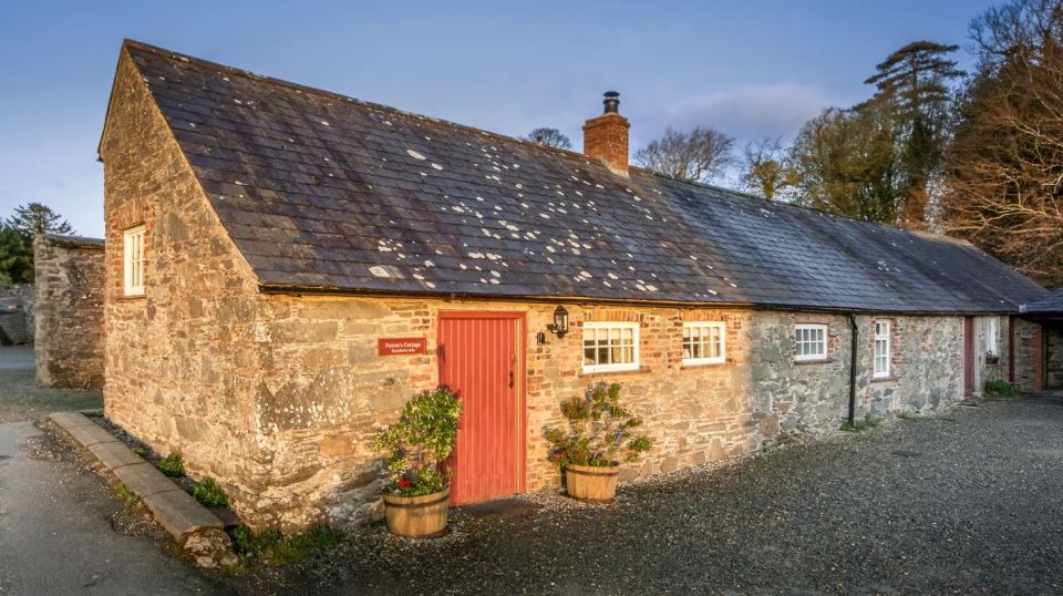 Potter's Cottage, a stone building with a red door.