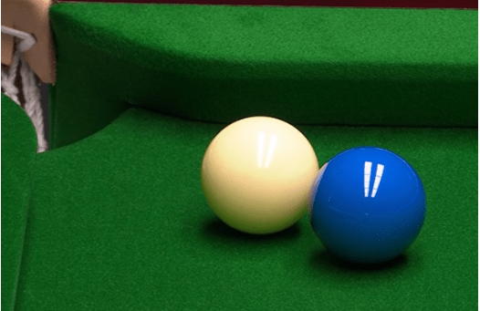 Two billiard balls on a pool table.