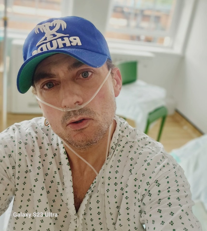 Man in hospital gown and nasal cannula.