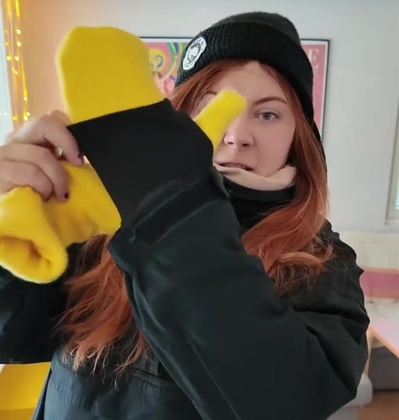 Woman demonstrating how to wear mittens in -15 degree weather.