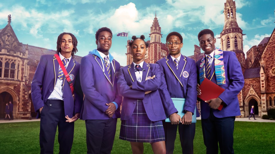 Five students in school uniforms stand in front of a school building.