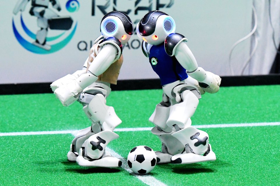 Two robots playing soccer.