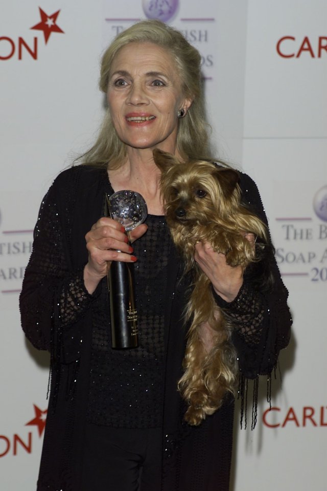 Sherlie Stelfox holding a soap award and a Yorkshire Terrier.