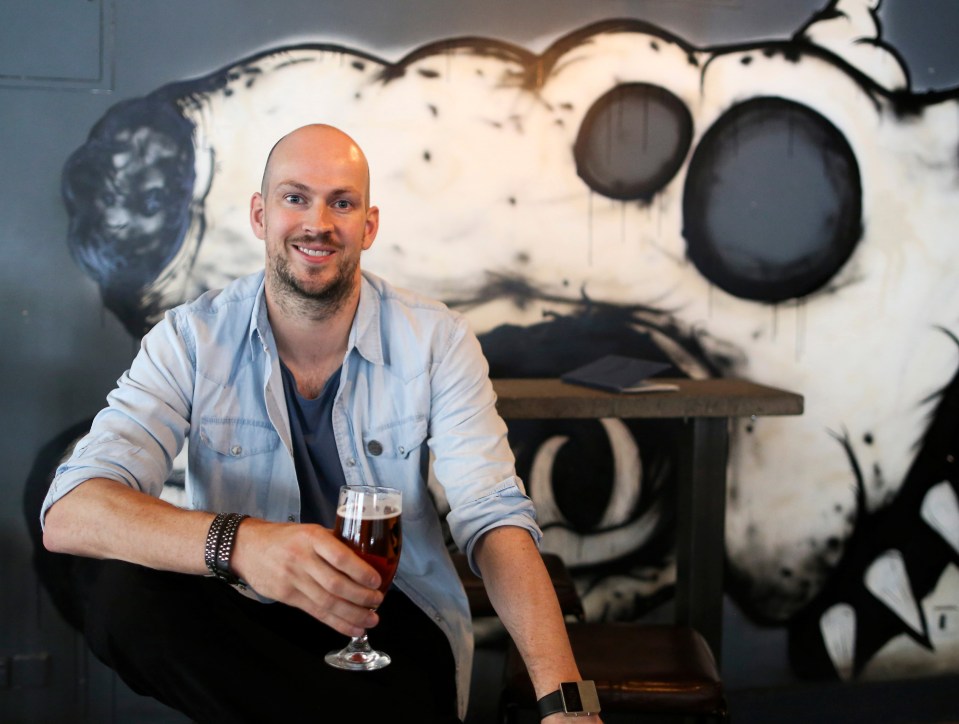 Portrait of James Watt, Brewdog CEO, holding a beer.