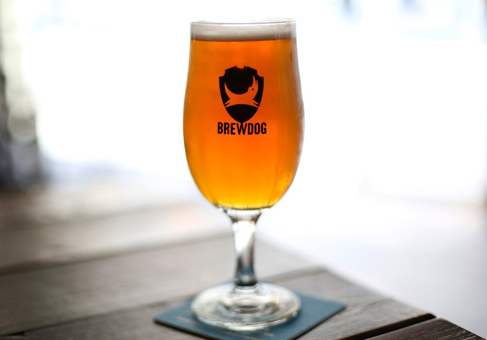 A glass of Brewdog pale ale on a table.