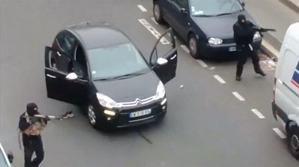 Gunmen flee the offices of French satirical newspaper Charlie Hebdo in Paris in 2015