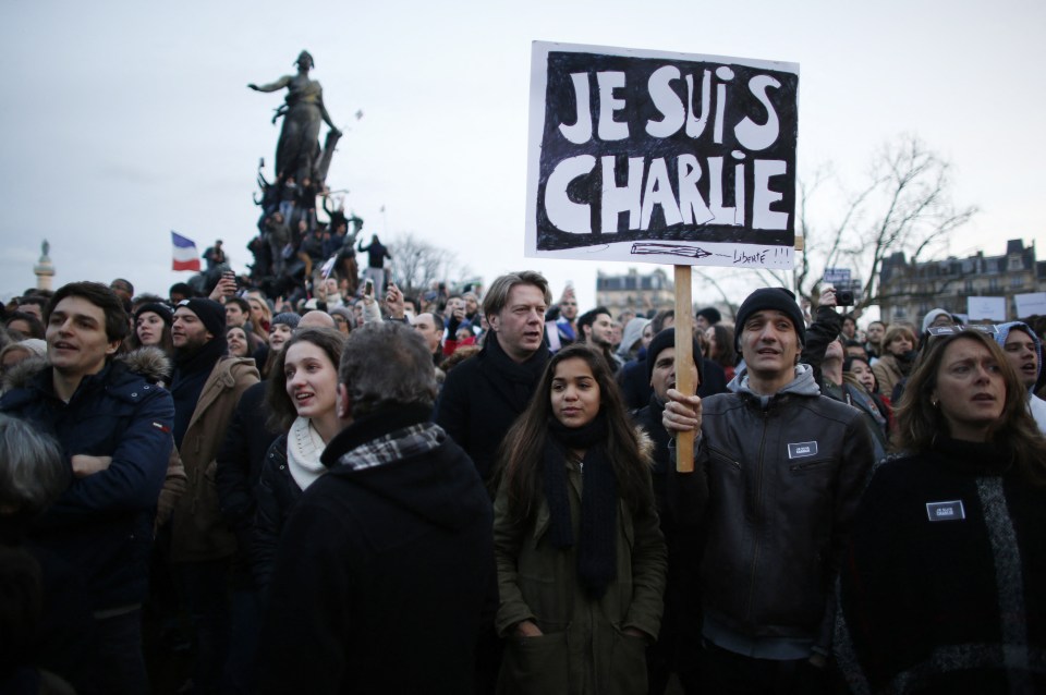 People holding cardboards reading 'Je suis Charlie' (I am Charlie) take part in a Unity rally 'Marche Republicaine' in 2015