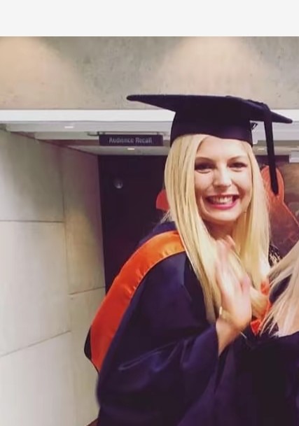 Young woman in graduation cap and gown.