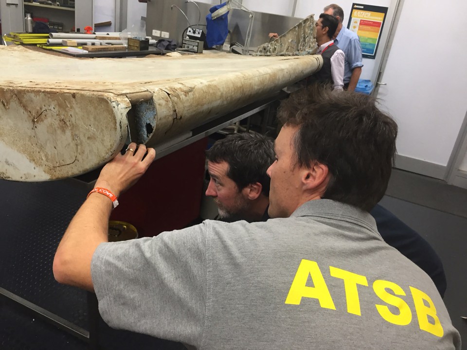 Officials inspecting debris from Malaysia Airlines Flight 370.