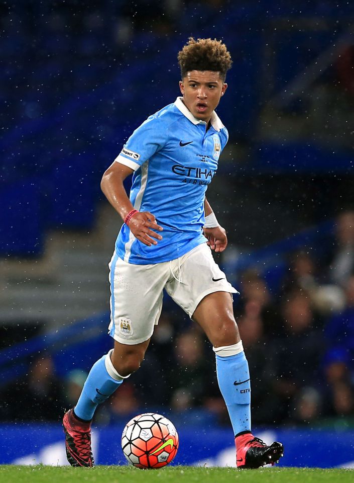 Jadon Sancho in a Manchester City uniform playing soccer.