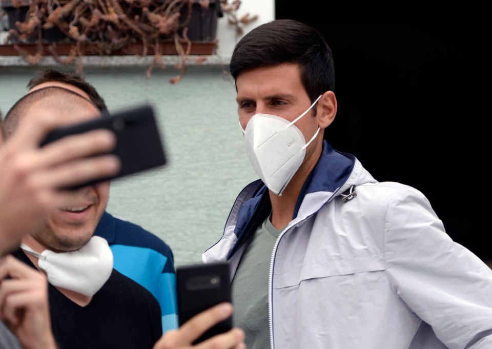 Novak Djokovic wearing a face mask, taking selfies with fans.