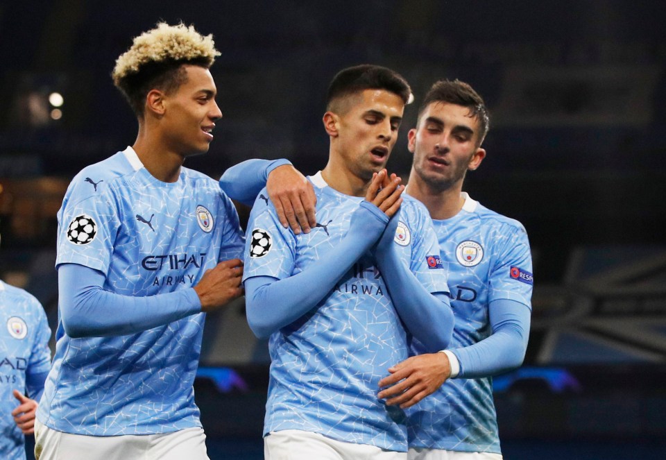 Manchester City players celebrating a goal.