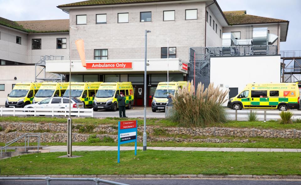 Ambulances parked outside a hospital emergency room.