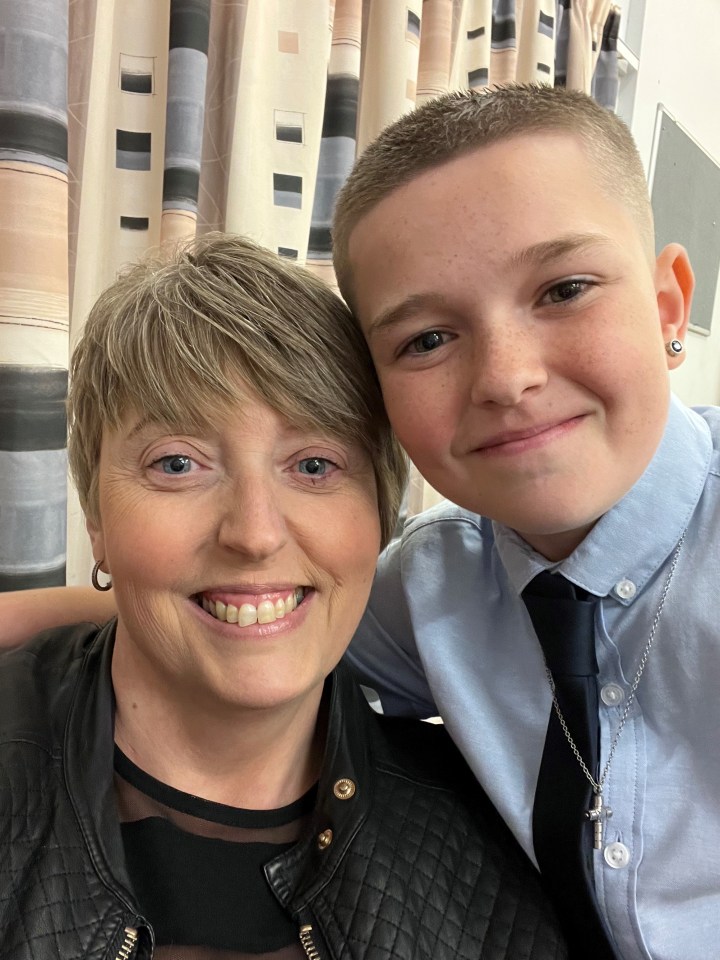 A woman and her teenage son pose for a selfie.