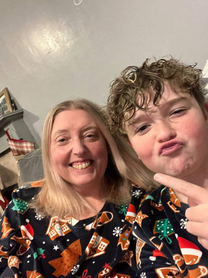 A woman and her son in matching Christmas pajamas.