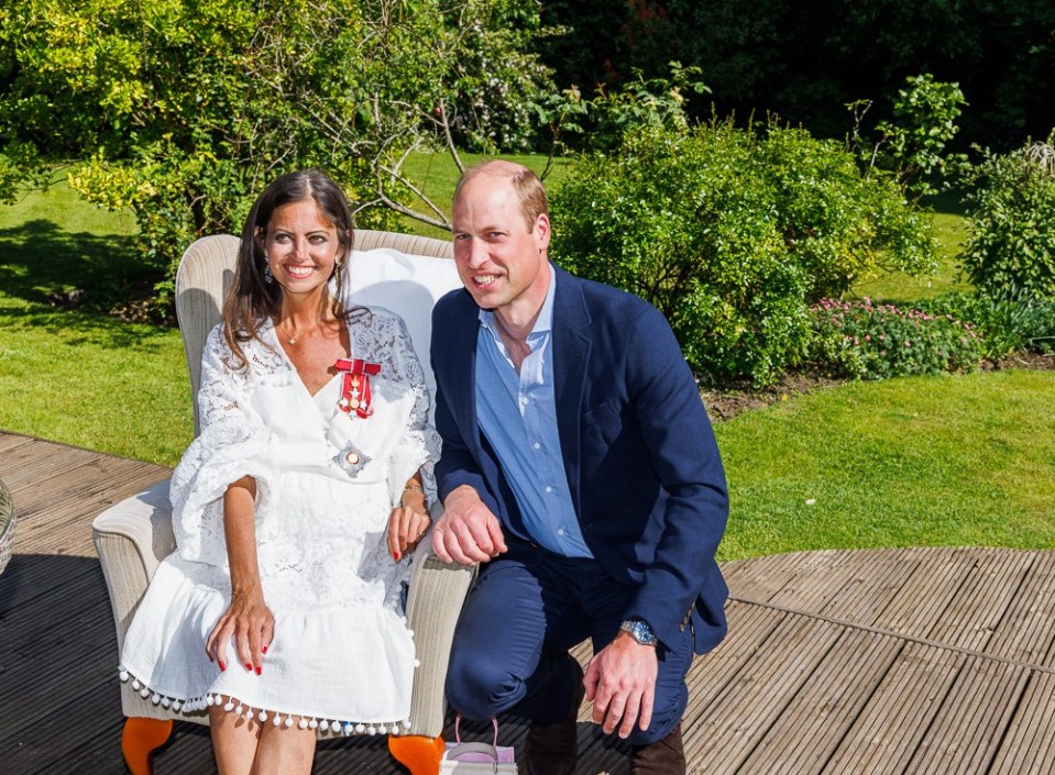 Prince William presents Deborah James with her Damehood.