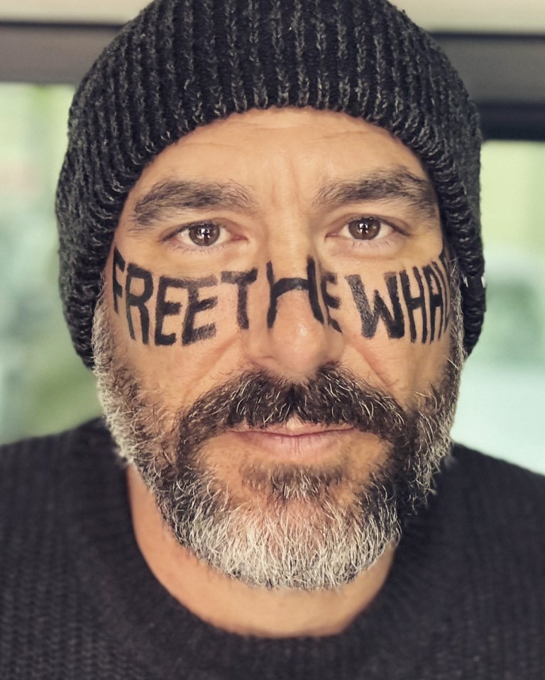 Man with "Free the Whale" written on his face.