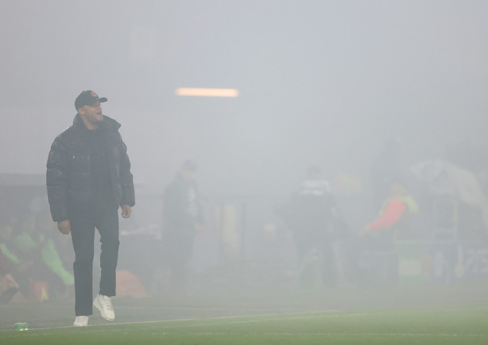 Bayern Munich's coach Vincent Kompany speaking with Minjae Kim on the sidelines.