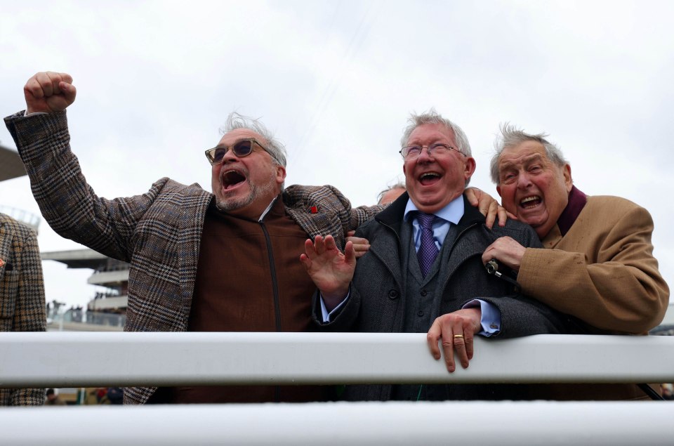 Three men celebrating at a horse race.