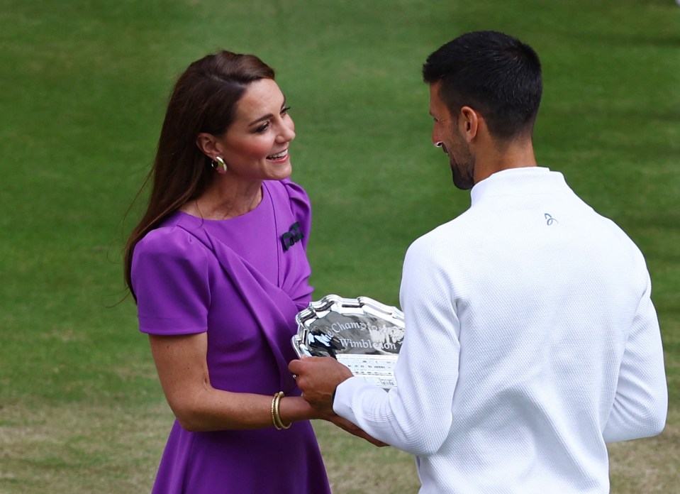 Catherine, Princess of Wales, presents Novak Djokovic with the Wimbledon runner-up trophy.