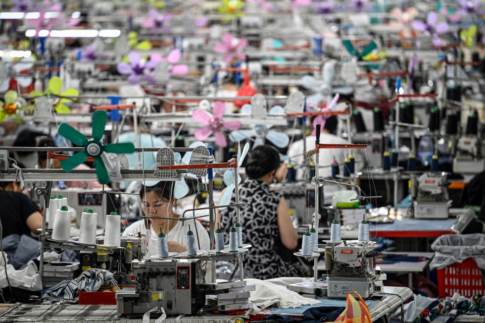 Workers operating sewing machines in a garment factory.