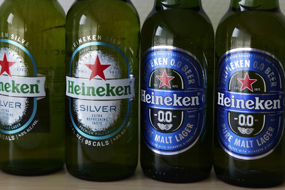 Four Heineken beer bottles; two are Heineken Silver, and two are Heineken 0.0.