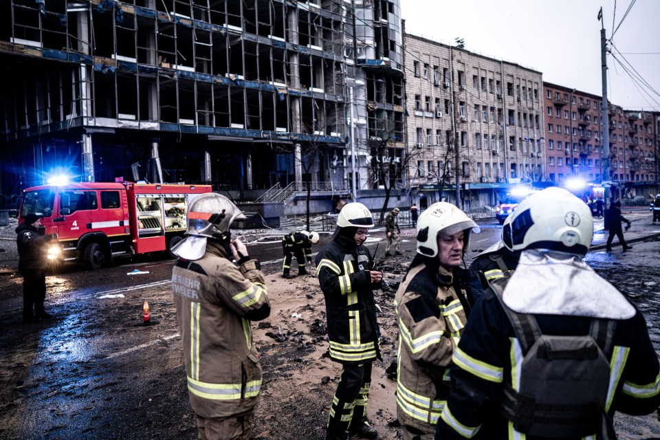 Firefighters at the scene of a missile attack.