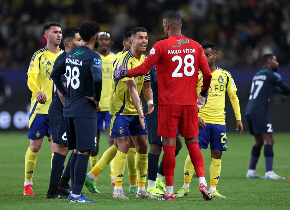 Cristiano Ronaldo of Al Nassr speaks with Paulo Vitor of Al Okhdood.