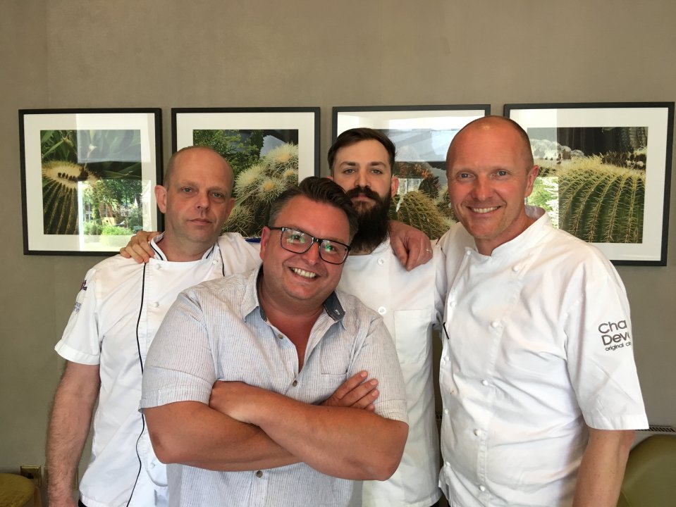 Four chefs posing for a photo.