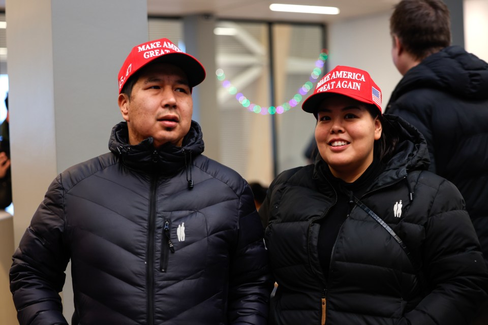 Two people wearing "Make America Great Again" hats.