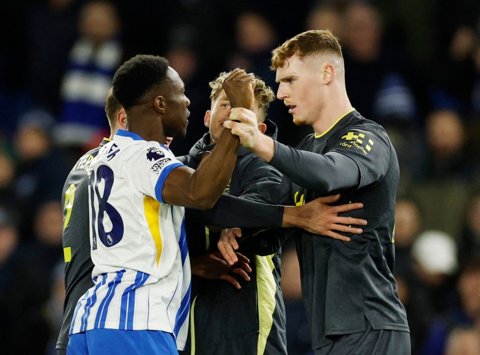 Everton's Jake O'Brien and Brighton's Danny Welbeck clashing during a soccer match.