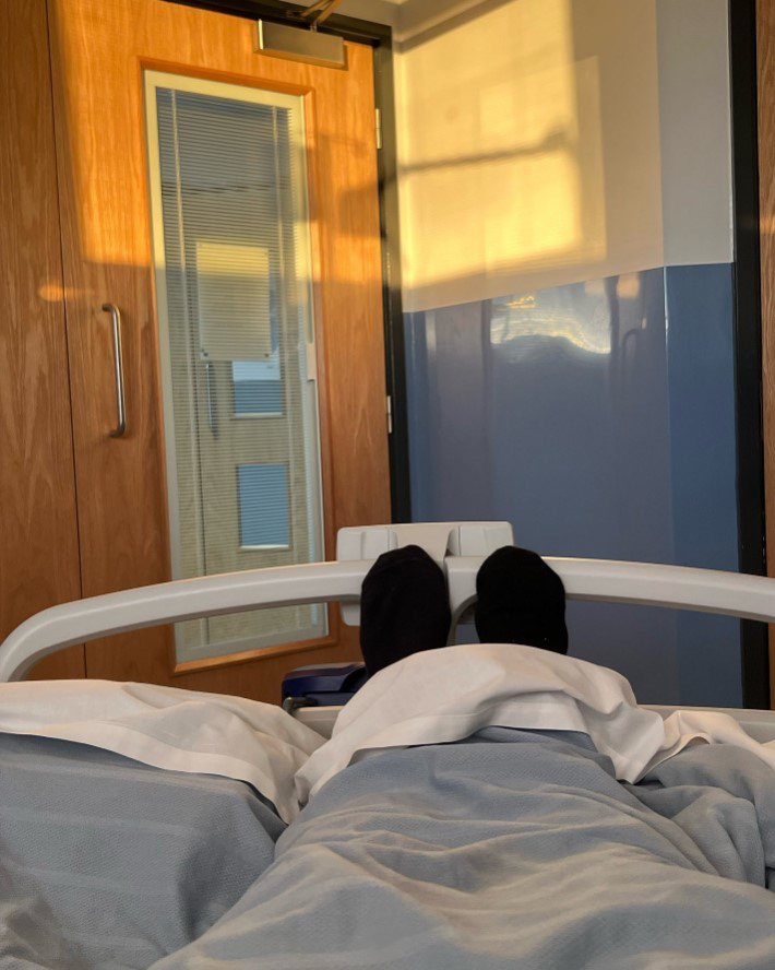 Person's feet in hospital bed.