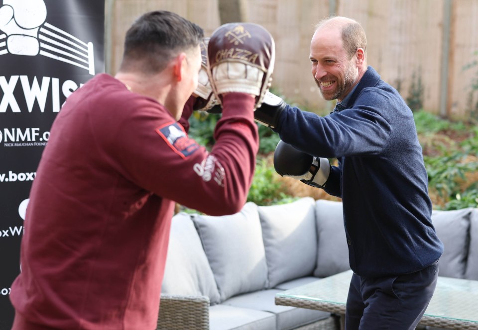 Prince William boxing with a young person at a Centrepoint charity event.