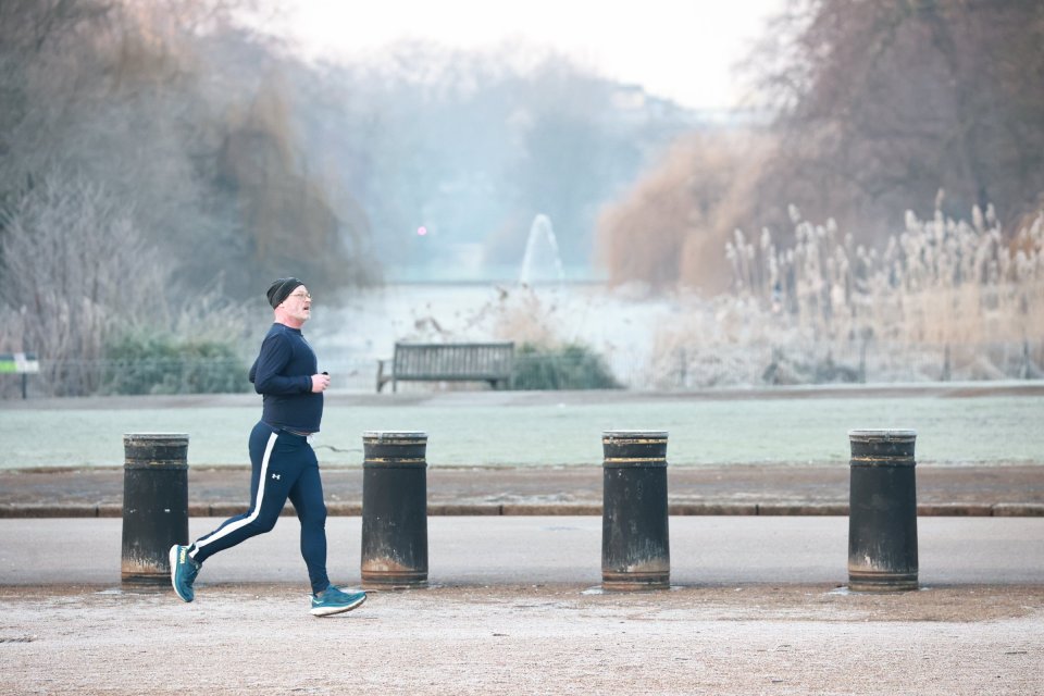 Runner jogging in a frosty park.