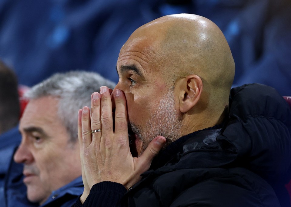 Pep Guardiola, Manchester City manager, looking concerned.