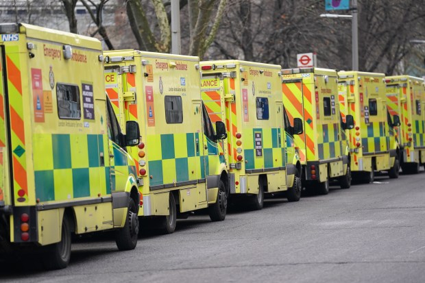 Row of London ambulances parked outside a control room.