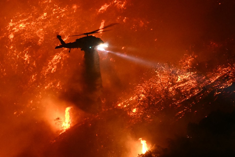 Helicopter dropping water on wildfire.