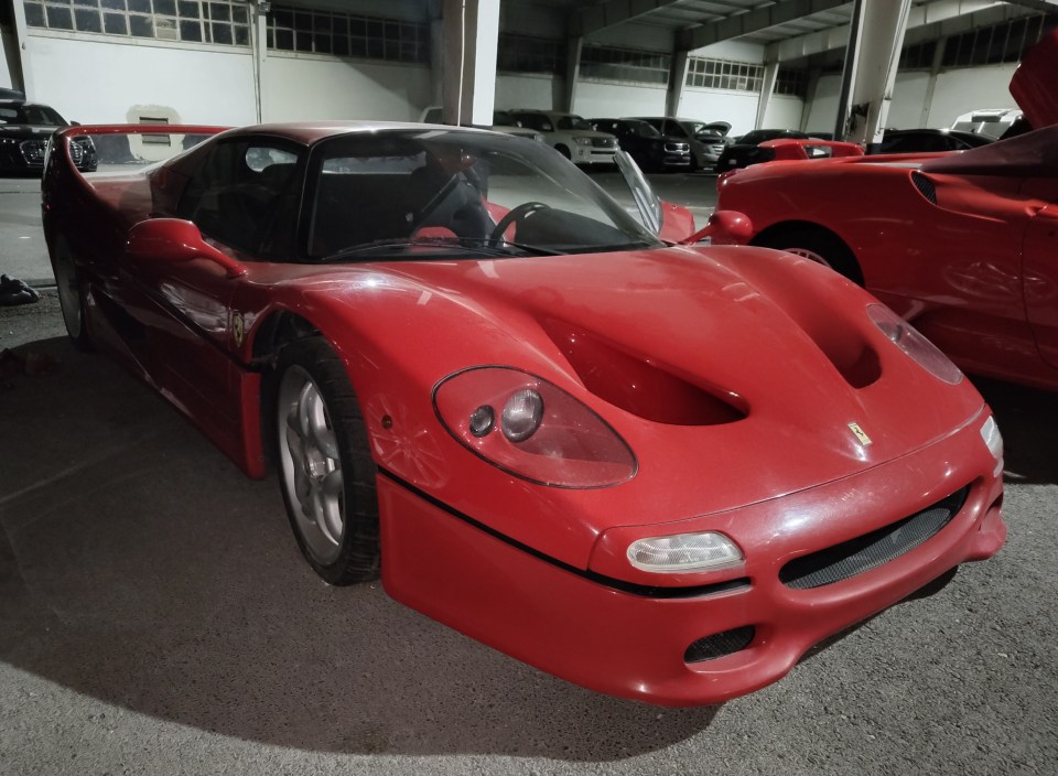 Red Ferrari F50 in a parking garage.