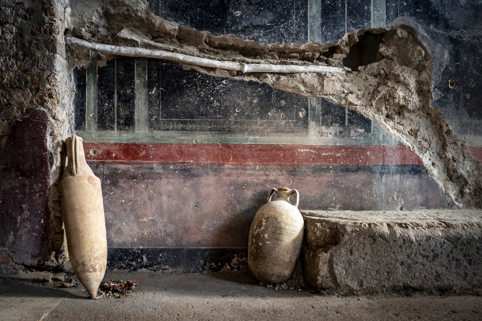 Two ancient amphorae in a Pompeii bathhouse.