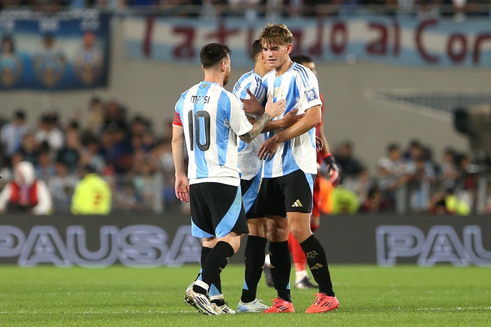 Lionel Messi congratulates a teammate after an Argentina win.