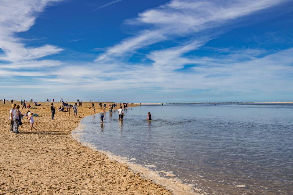 People enjoying Wells-next-the-Sea beach in North Norfolk, England.