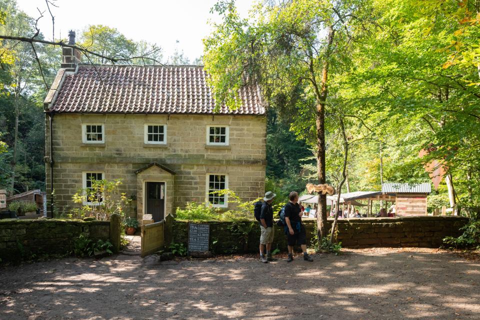 Stone tea garden building with two visitors.