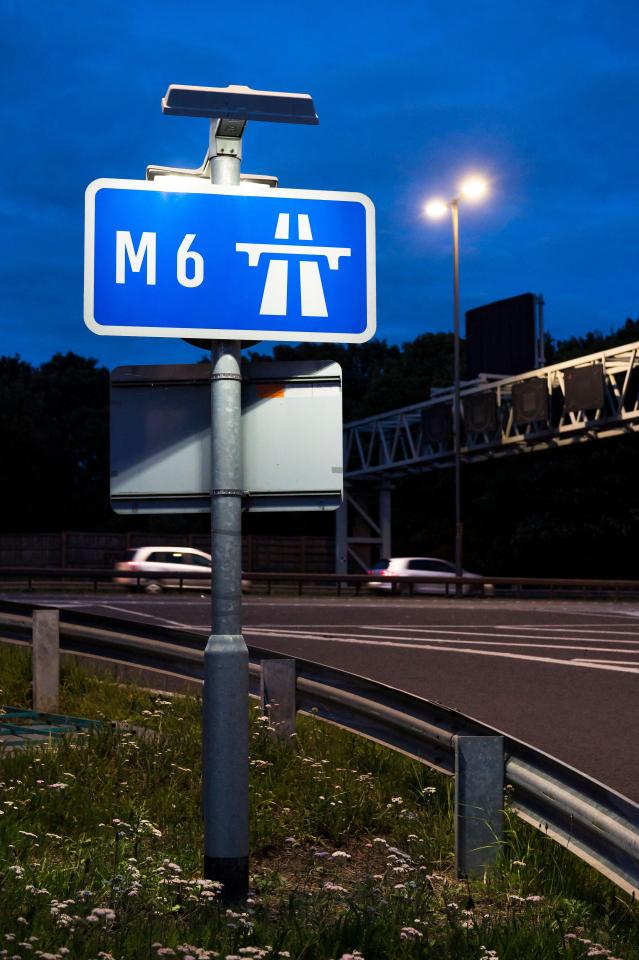 M6 motorway sign at night.