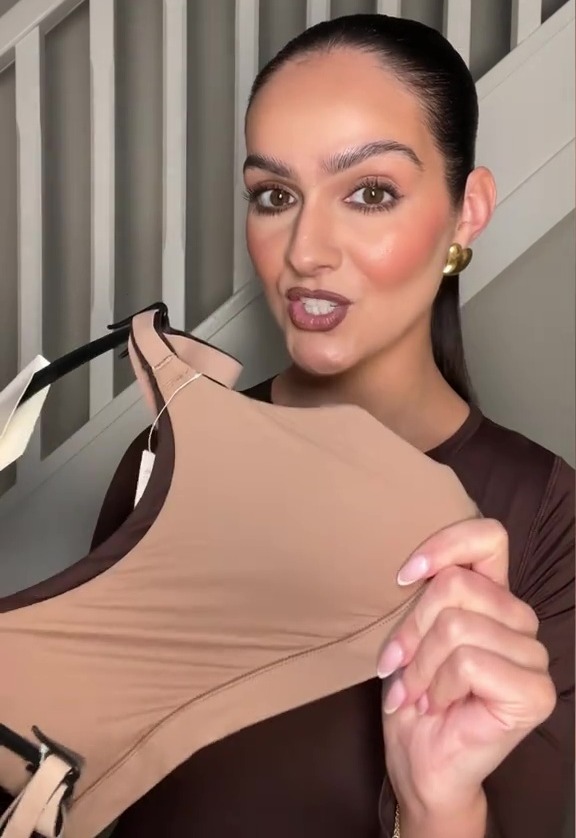 Woman shows off a nude-colored bra dupe.