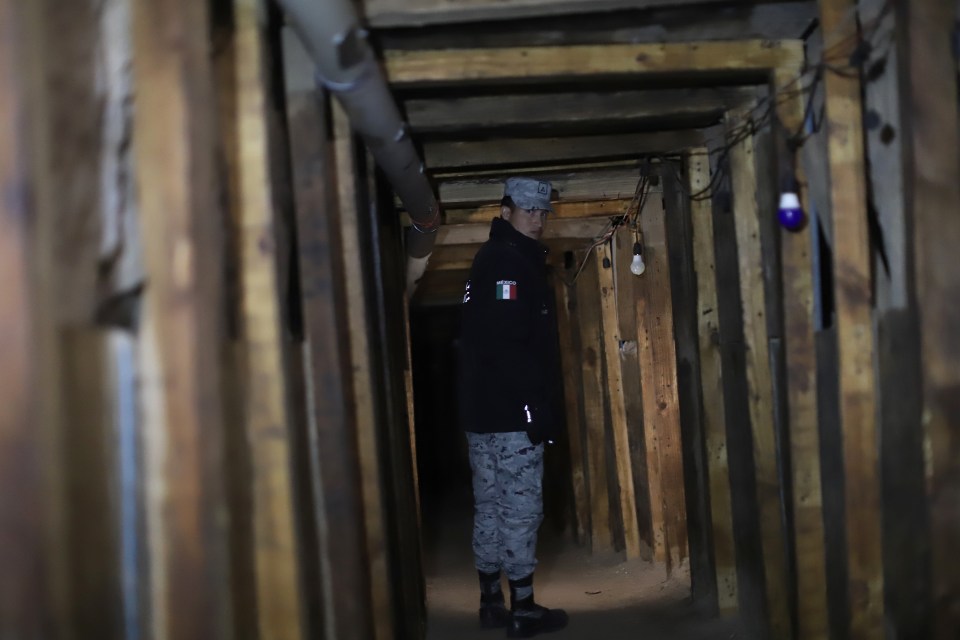 A Mexican official stands in a 300-meter cross-border tunnel.