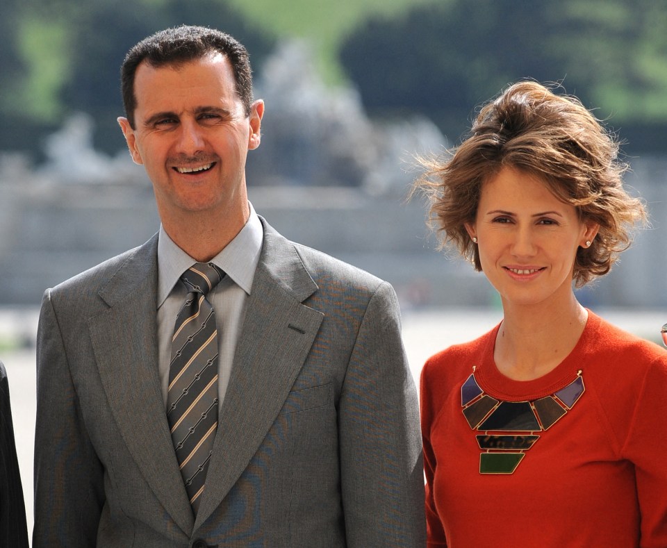 Bashar al-Assad and Asma al-Assad holding hands.