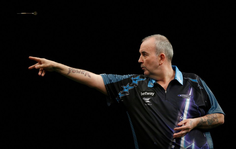 Phil Taylor throwing a dart.