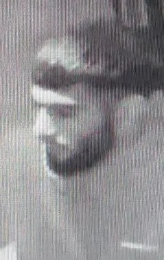 Low-quality CCTV image of a suspect.