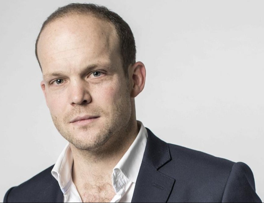 Headshot of a man in a suit.