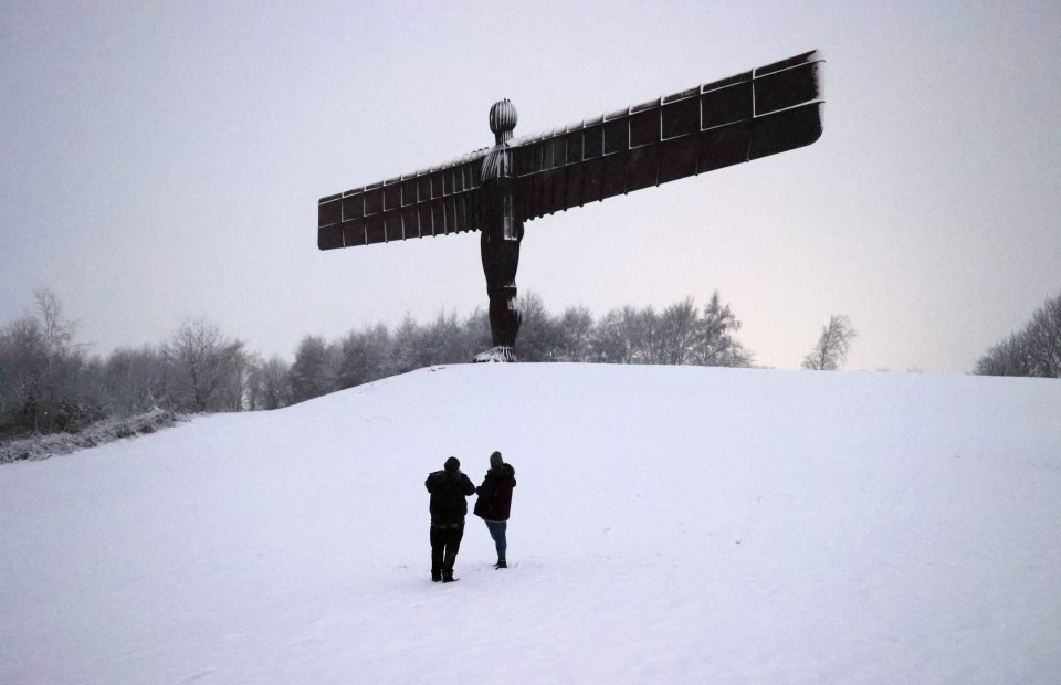 Snow covers the ground at the Angel of the North in Gateshead this morning